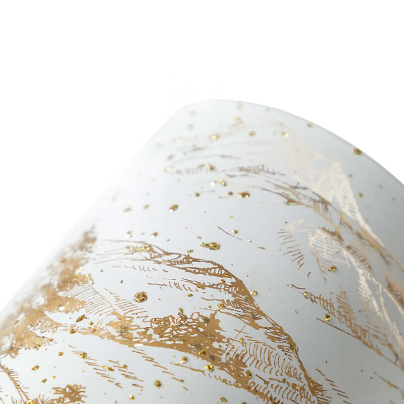 Close-up of Lumishade Candle with elegant gold detailing and specks, creating a luxurious atmosphere.