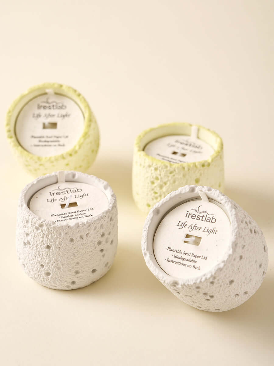 Four irestlab Seed Candles in textured holders, embodying sustainability and mindful living for inner peace.