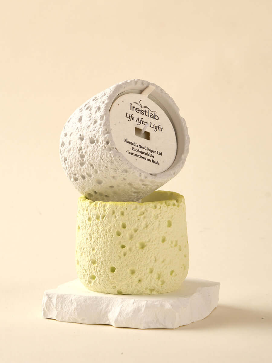 Irestlab Seed Candle in eco-friendly, textured holders: one white and one green, symbolizing sustainable living and mindfulness.